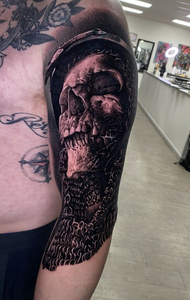 A Man Displaying a Skull Tattoo on His Arm