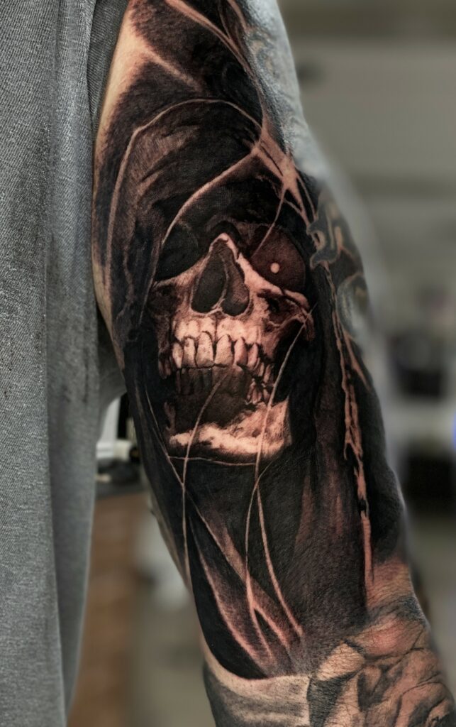 A Detailed Black and White Tattoo of a Skull