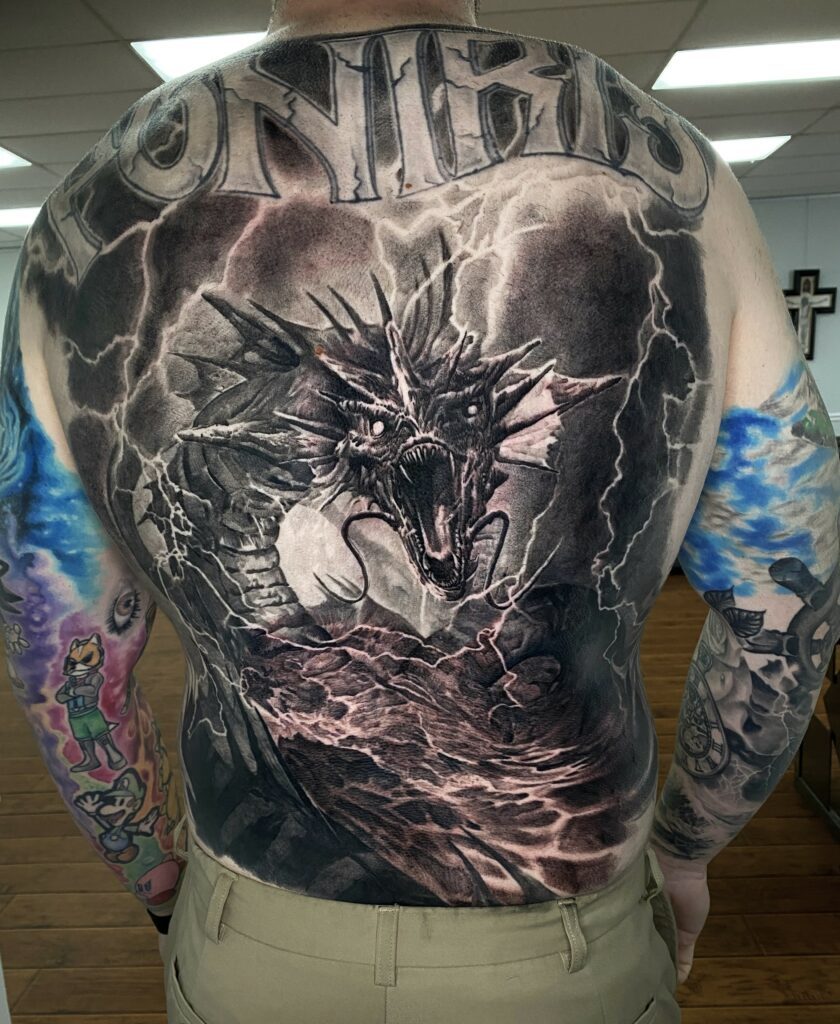 A Man Displays Intricate Tattoos on His Back