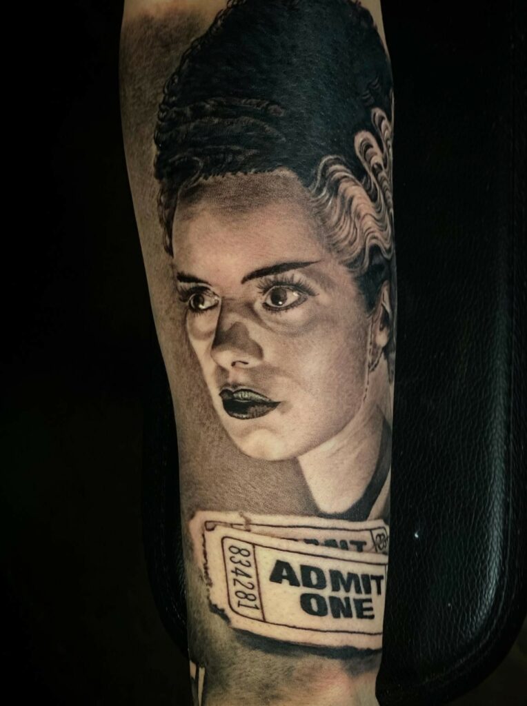 A Striking Tattoo Featuring a Woman’s Face Artistically Rendered on an Individual’s Arm