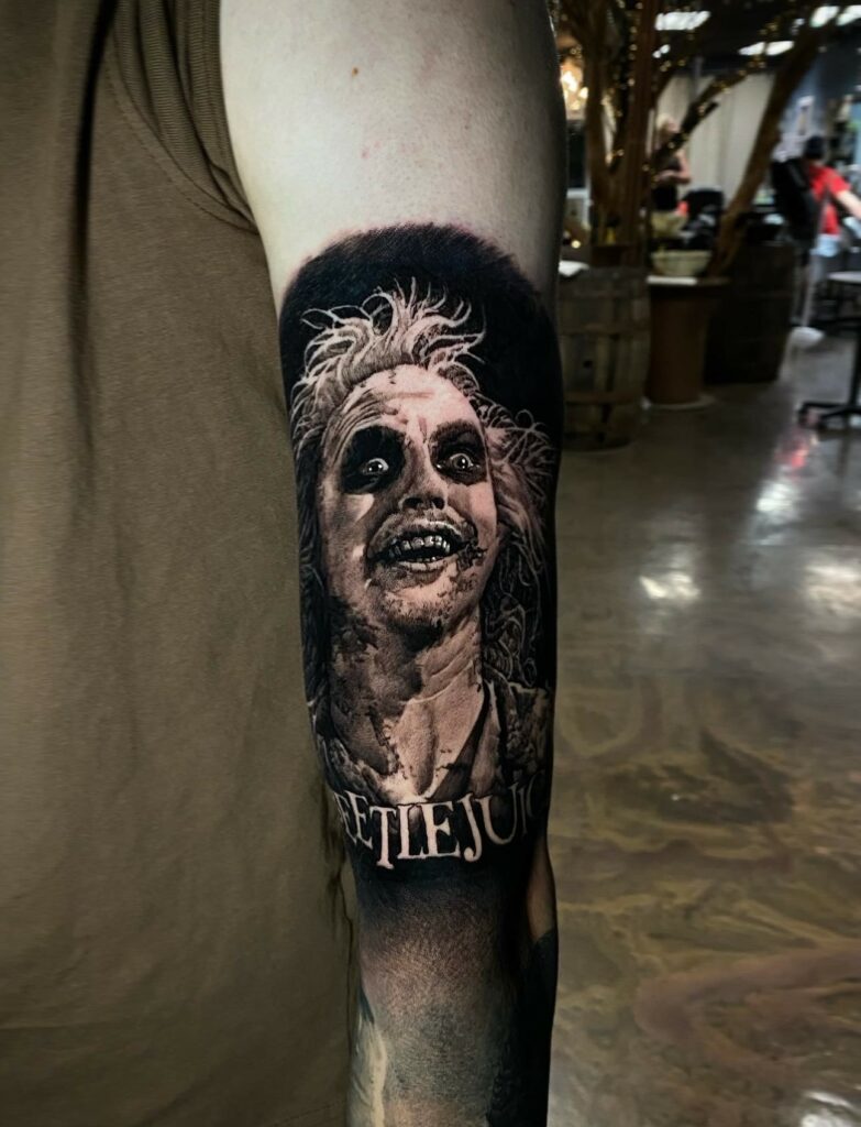 A Detailed Tattoo of a Clown Inked on a Person’s Arm