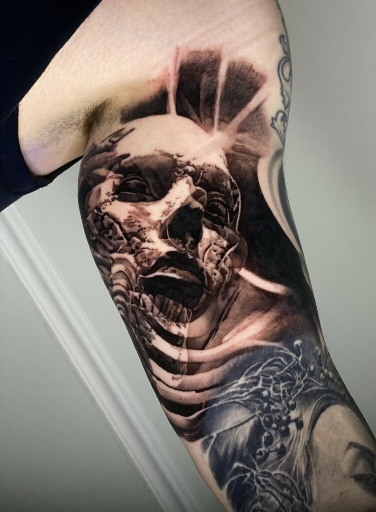 A Tattoo Featuring a Skull Intertwined with a Woman’s Face