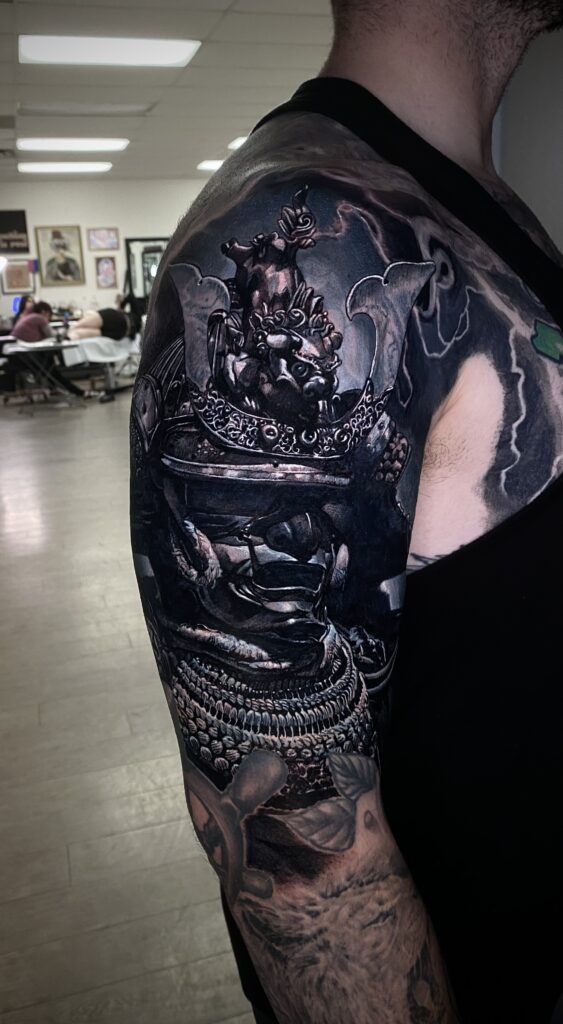 A Man Displaying Intricate Tattoos on His Arm and Shoulder