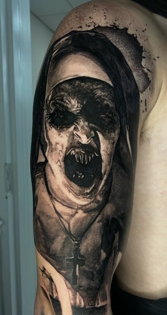 An Artistic Tattoo Featuring a Woman’s Face and a Cross