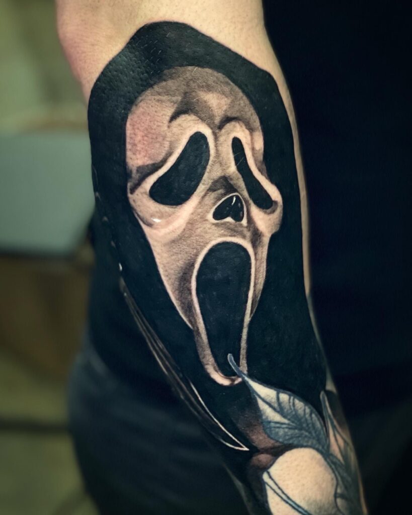 An Arm Adorned with a Tattoo of the Famous Scream Face