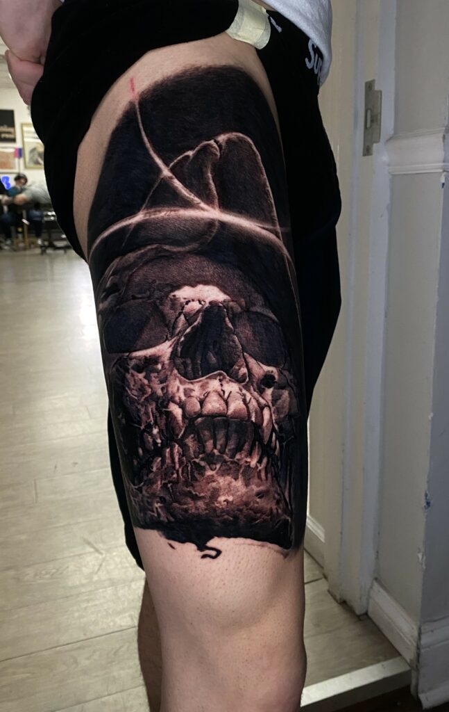 A Man with a Visible Skull Tattoo Inked on His Thigh