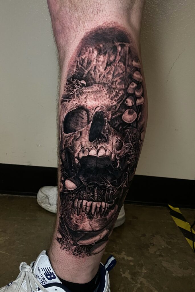 A Detailed Tattoo of a Skull on a Leg