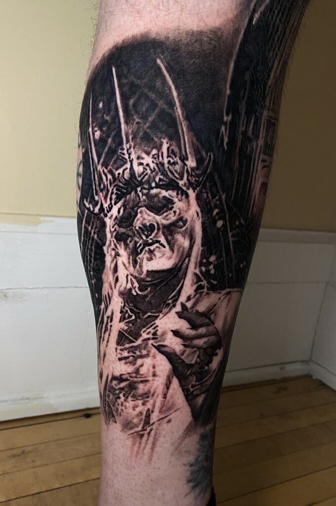 A Tattoo Depicting a Man Wearing a Crow