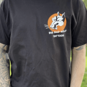 A Man Dressed in a Black Shirt Adorned with an Orange